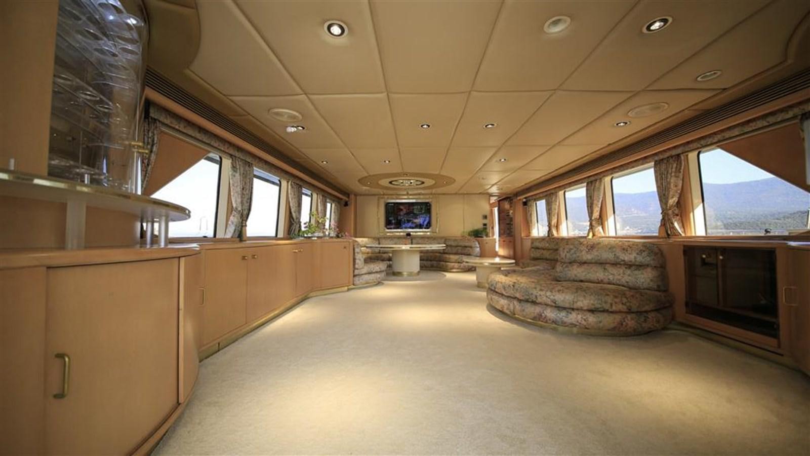 a room with a couch and a tv on the wall aboard AGARTHA Yacht for Sale