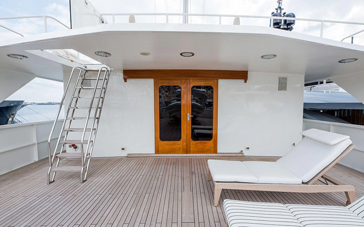 a room with a bed and a staircase aboard NOSTALGIA Yacht for Sale