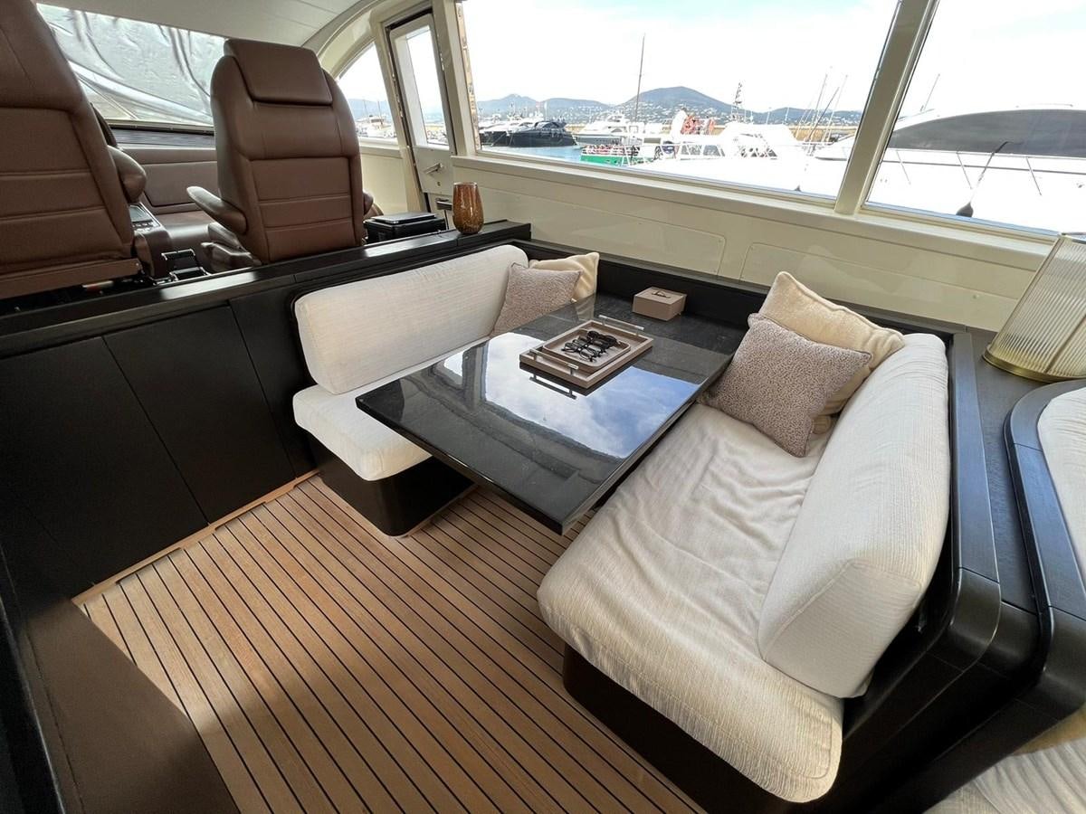 a room with a couch and a table with a coffee table aboard SAGA ONE Yacht for Sale