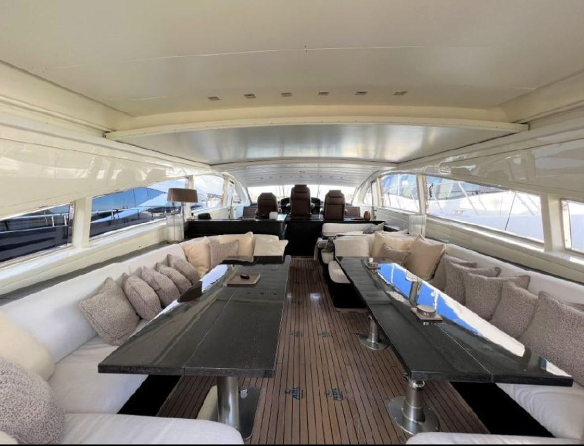 a room with a couch and a table with a laptop on it aboard SAGA ONE Yacht for Sale