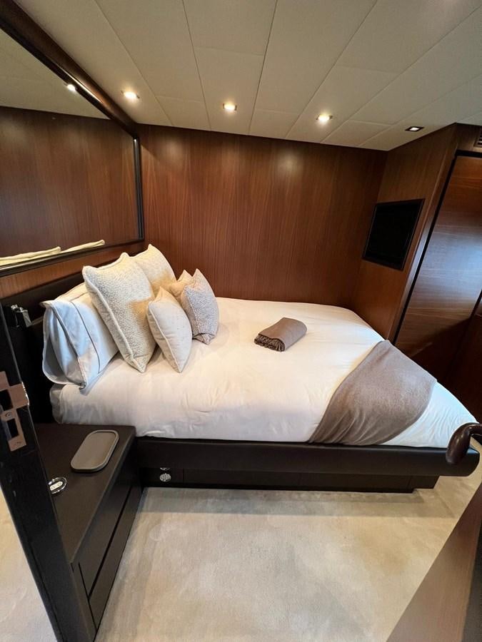 a bed with a white sheet and pillows on it aboard SAGA ONE Yacht for Sale