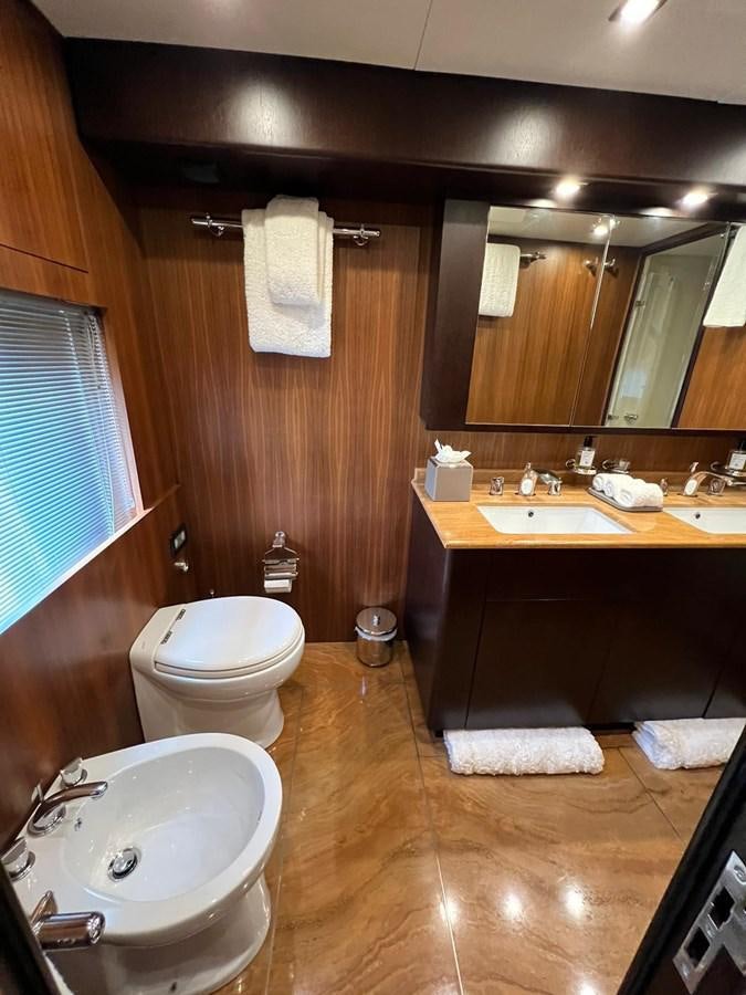 a bathroom with a sink toilet and a mirror aboard SAGA ONE Yacht for Sale