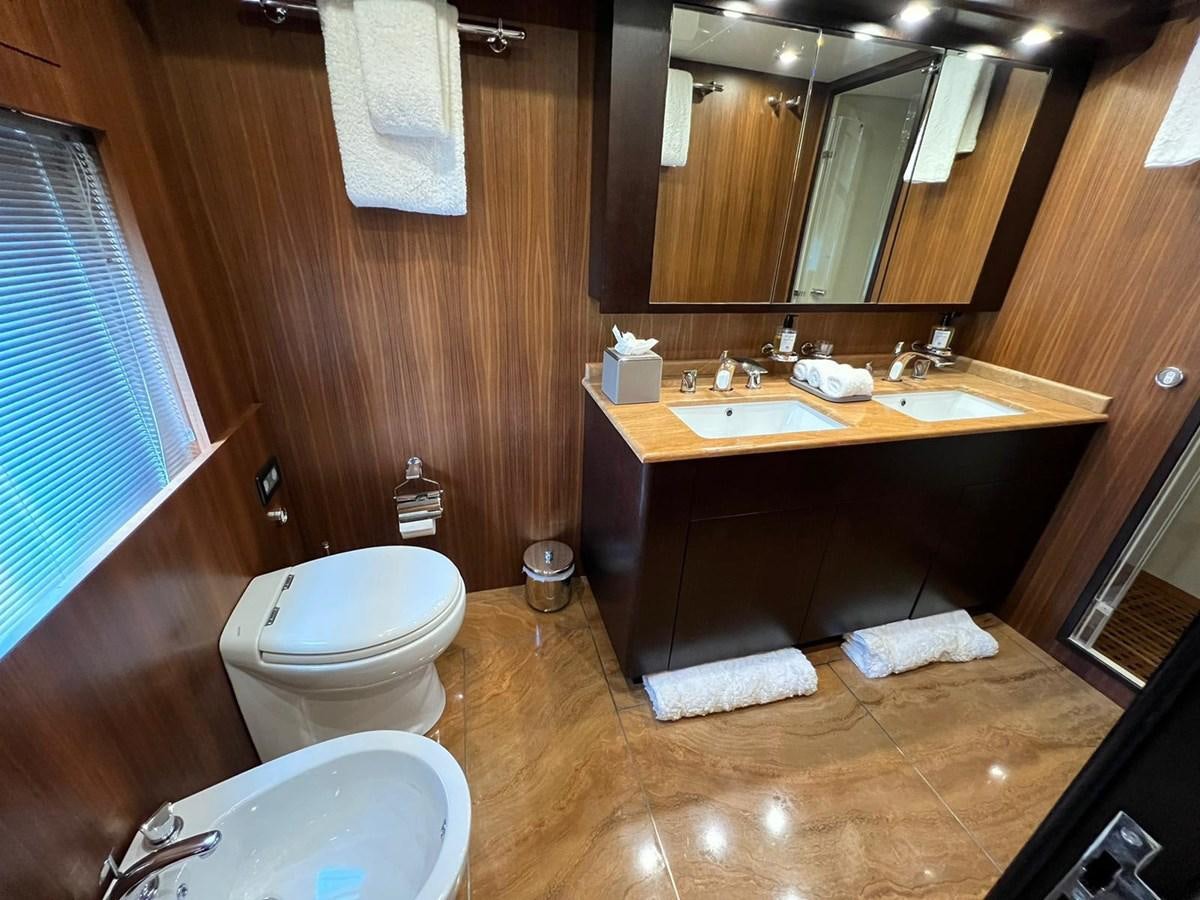 a bathroom with a sink toilet and a mirror aboard SAGA ONE Yacht for Sale