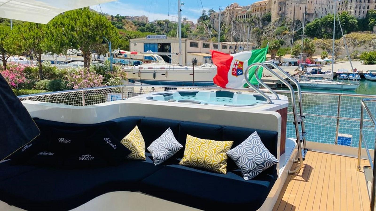 a boat with pillows on a deck aboard MR GU Yacht for Sale