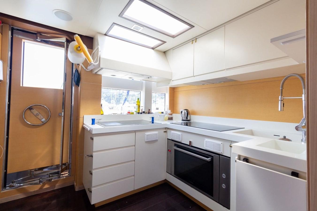 a kitchen with white cabinets aboard MR GU Yacht for Sale