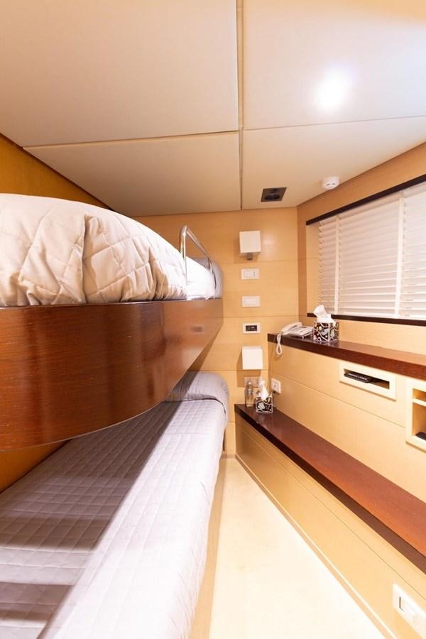 a bedroom with a bed and a window aboard MR GU Yacht for Sale