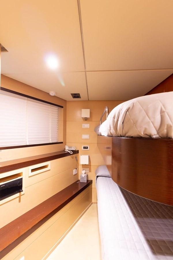 a room with a bed and a window aboard MR GU Yacht for Sale