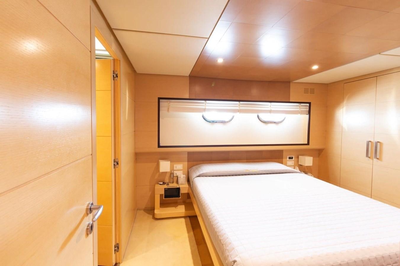 a room with a bed and a window aboard MR GU Yacht for Sale