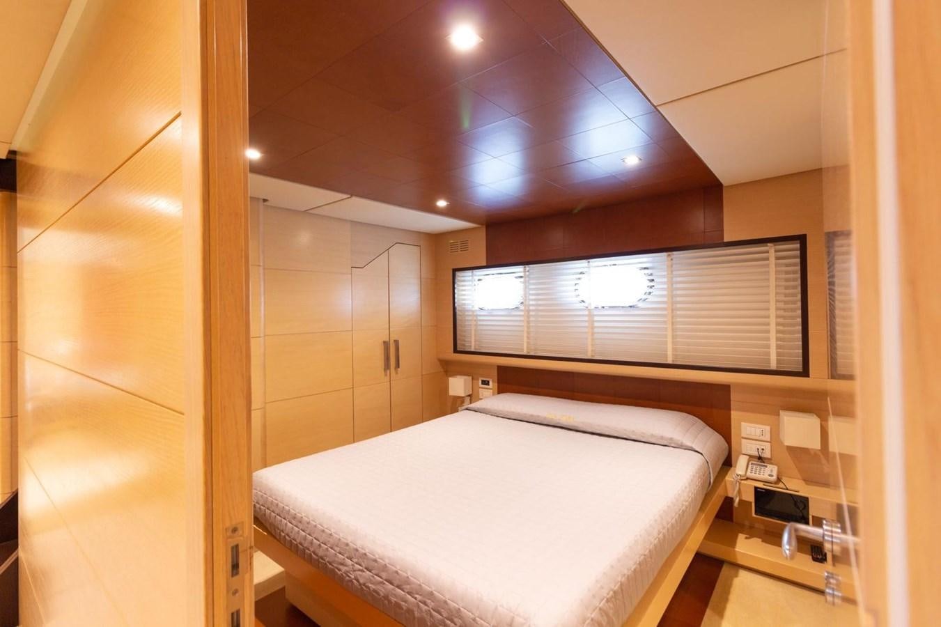a bed in a room aboard MR GU Yacht for Sale
