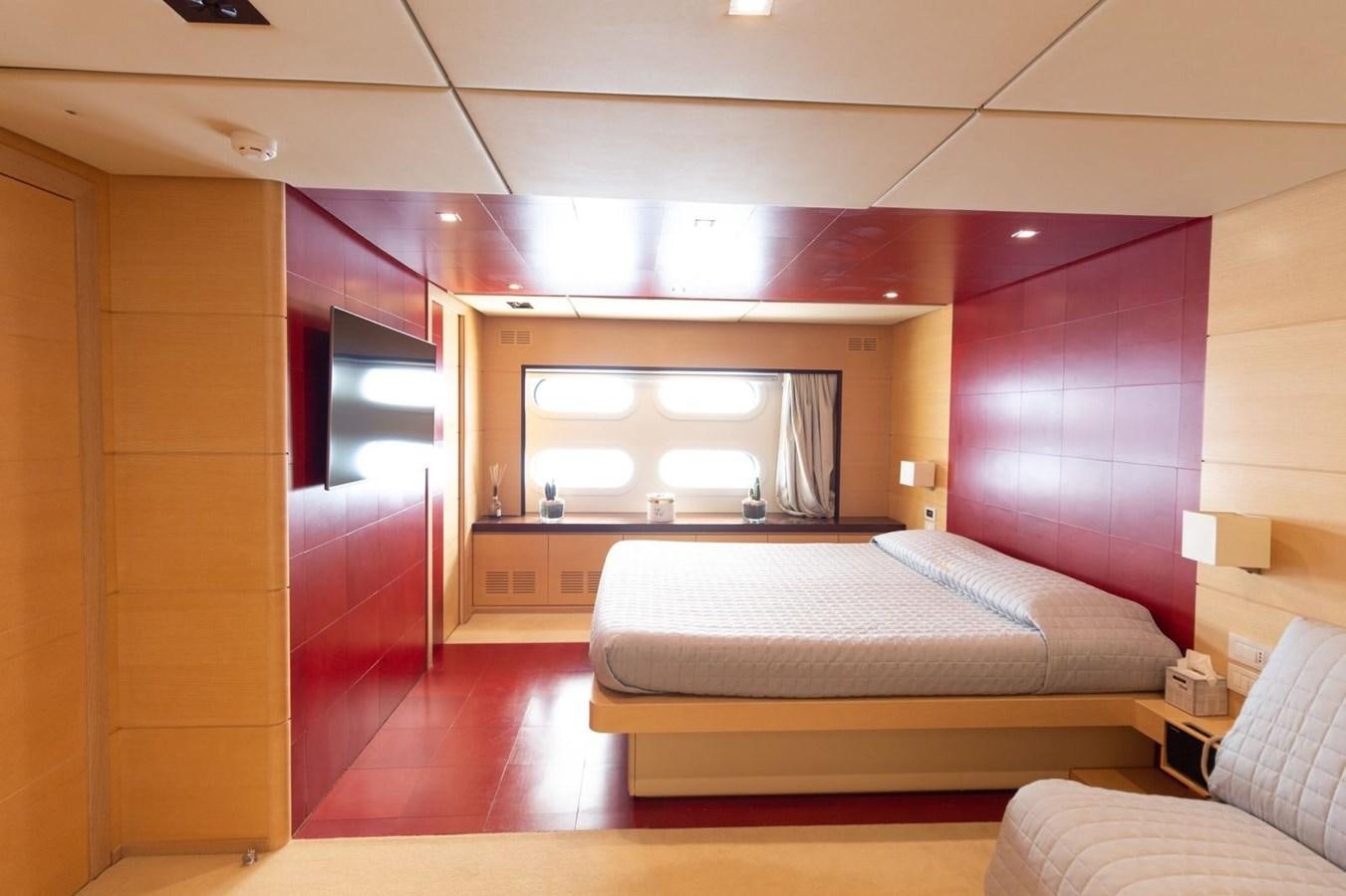 a room with a bed and a television aboard MR GU Yacht for Sale
