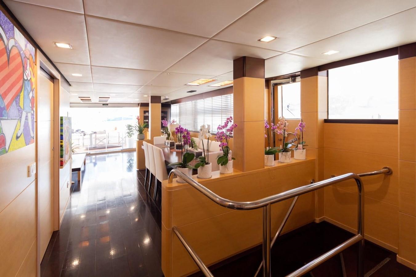 a hallway with a table and chairs aboard MR GU Yacht for Sale