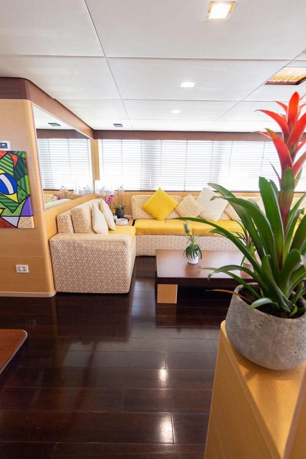 a living room with a couch and a plant aboard MR GU Yacht for Sale