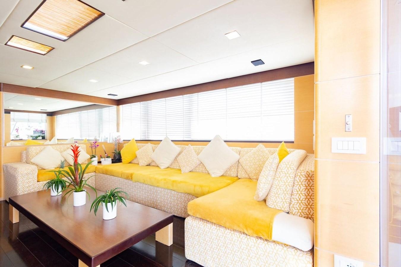 a living room with a couch and a table aboard MR GU Yacht for Sale