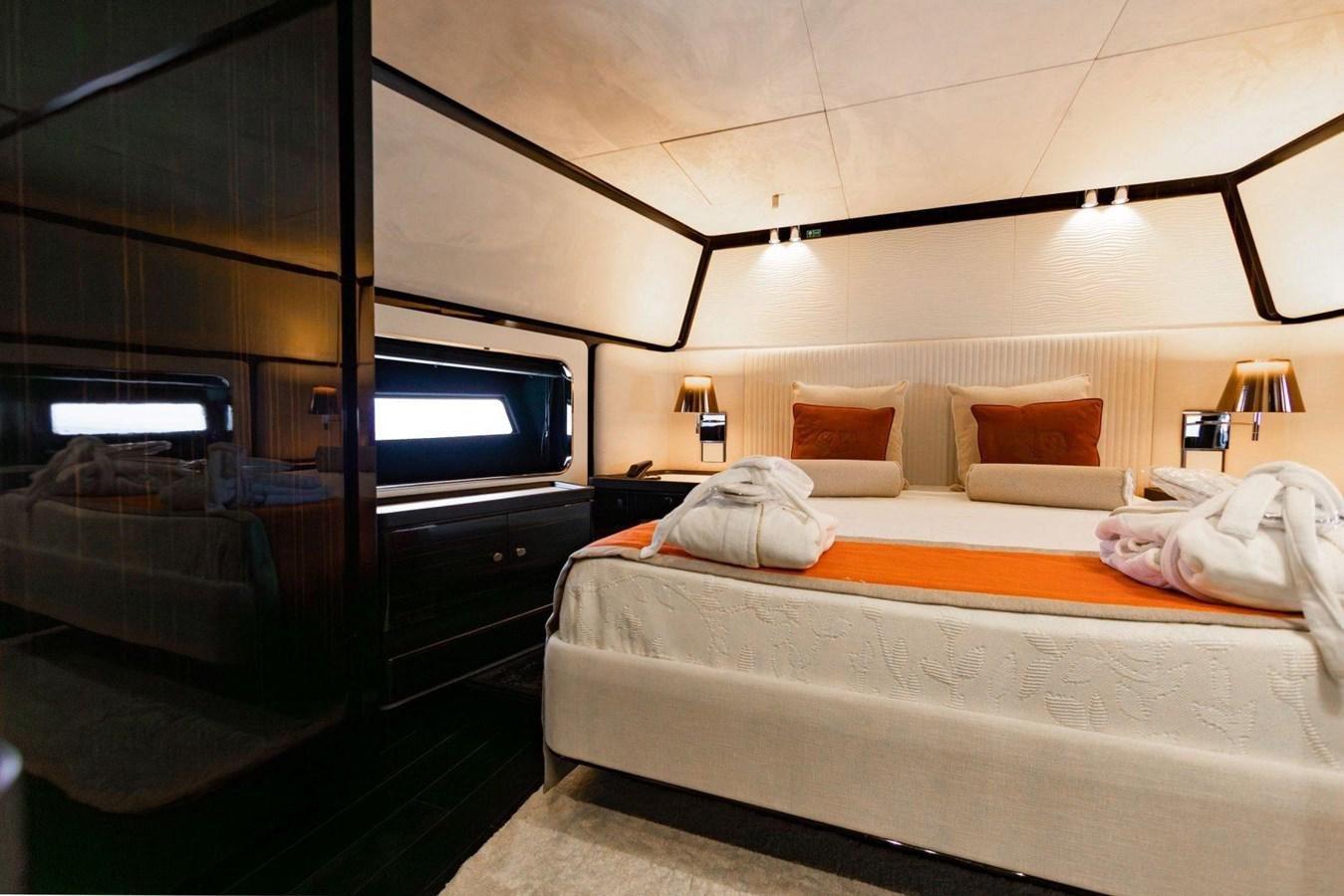 a bedroom with a bed and a tv aboard POSILLIPO TECHNEMA 90 Yacht for Sale