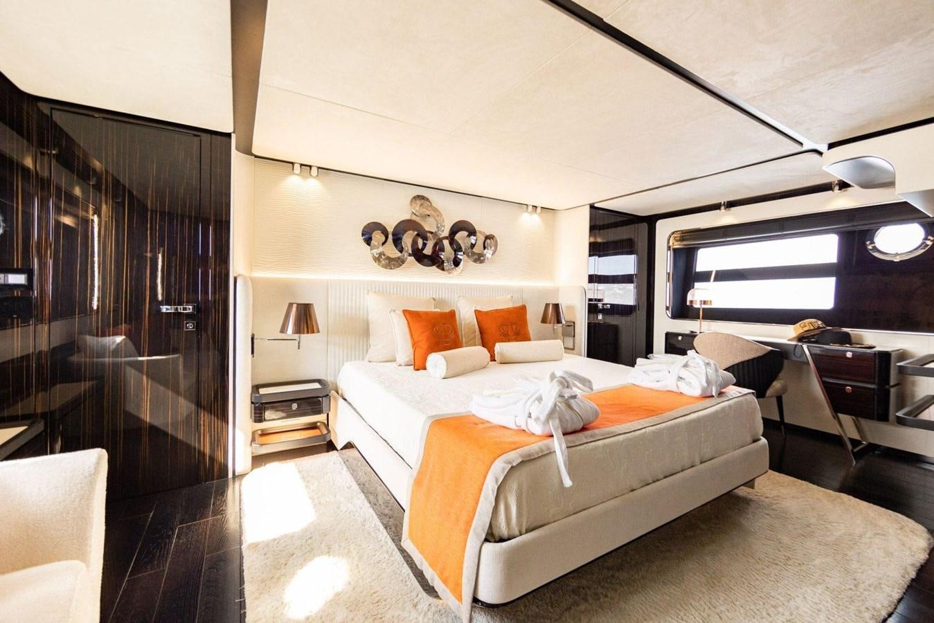 a bedroom with a bed and a window aboard POSILLIPO TECHNEMA 90 Yacht for Sale