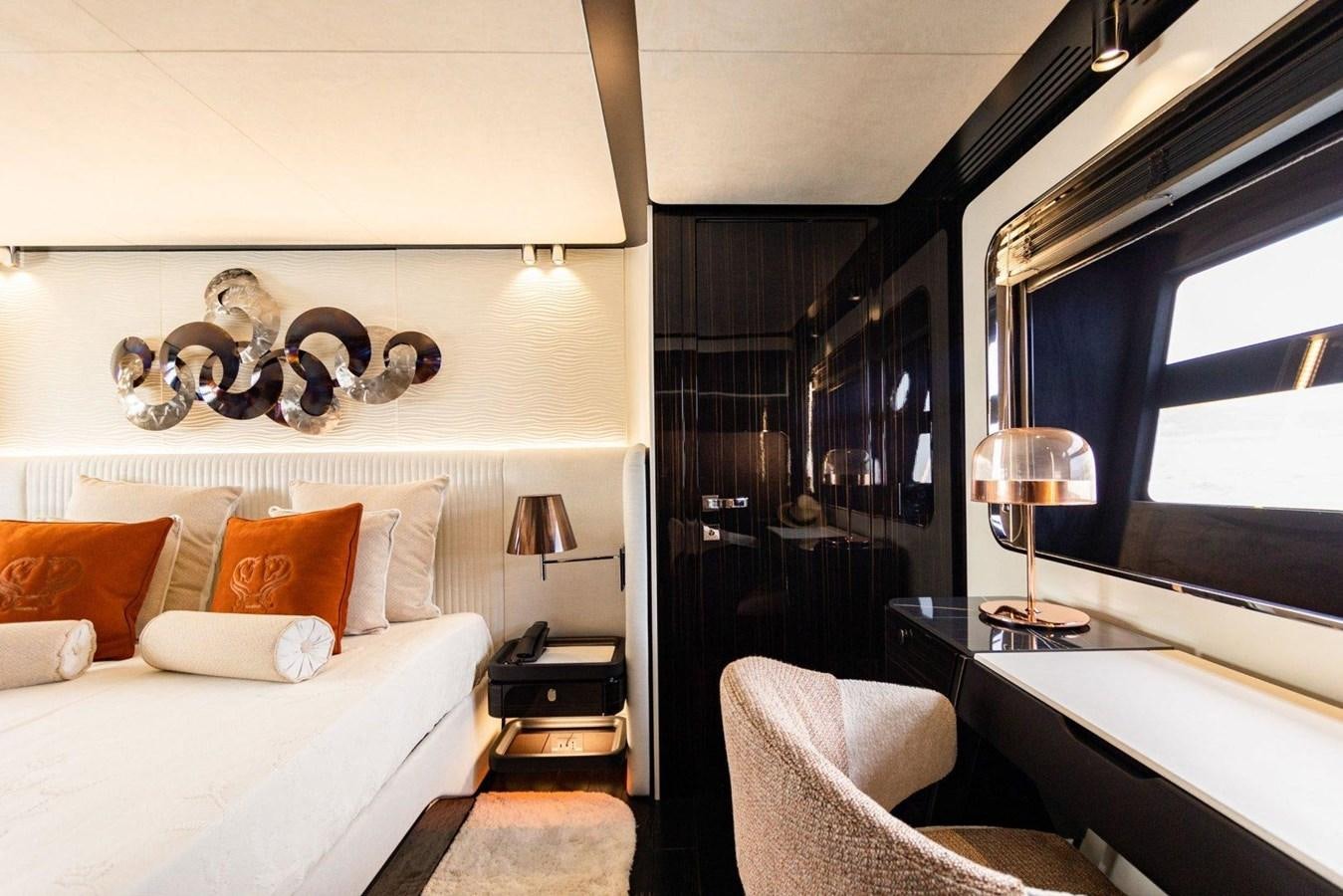a room with a bed and a table aboard POSILLIPO TECHNEMA 90 Yacht for Sale