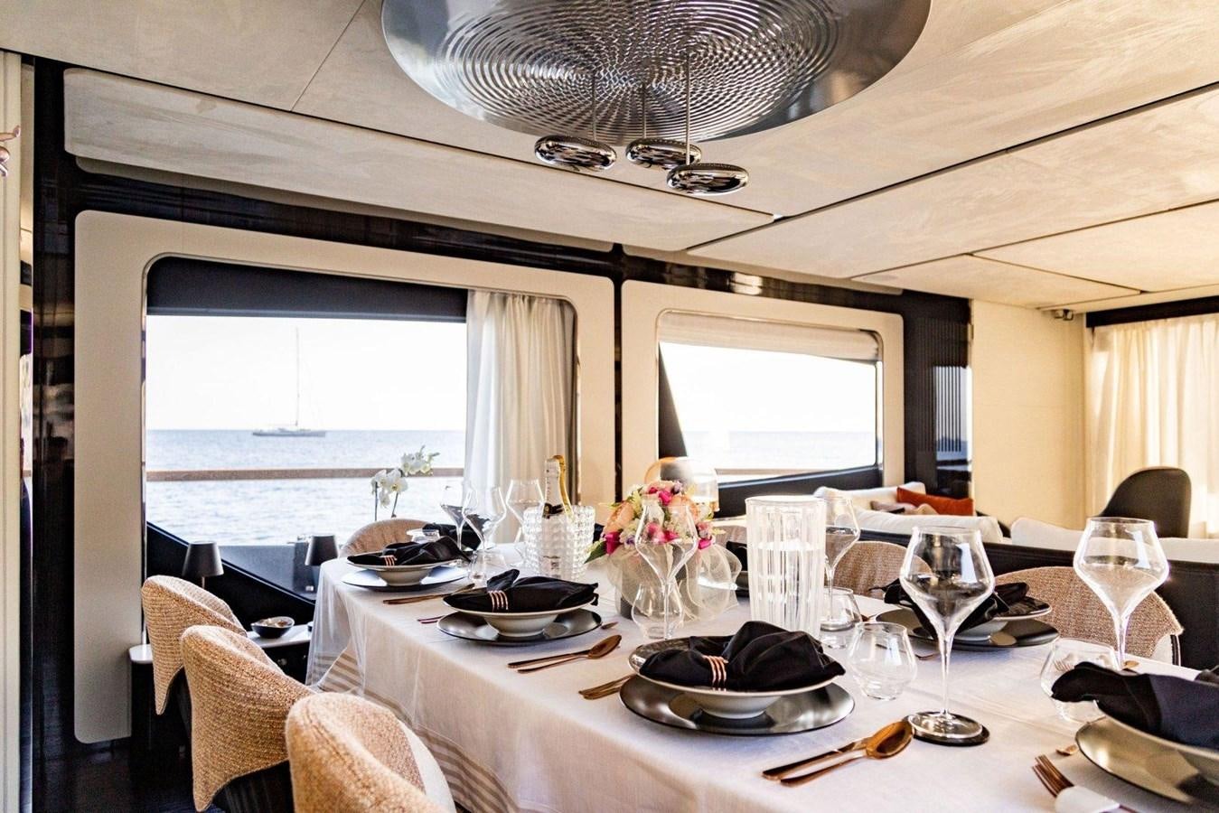 a dining table with plates and glasses aboard POSILLIPO TECHNEMA 90 Yacht for Sale