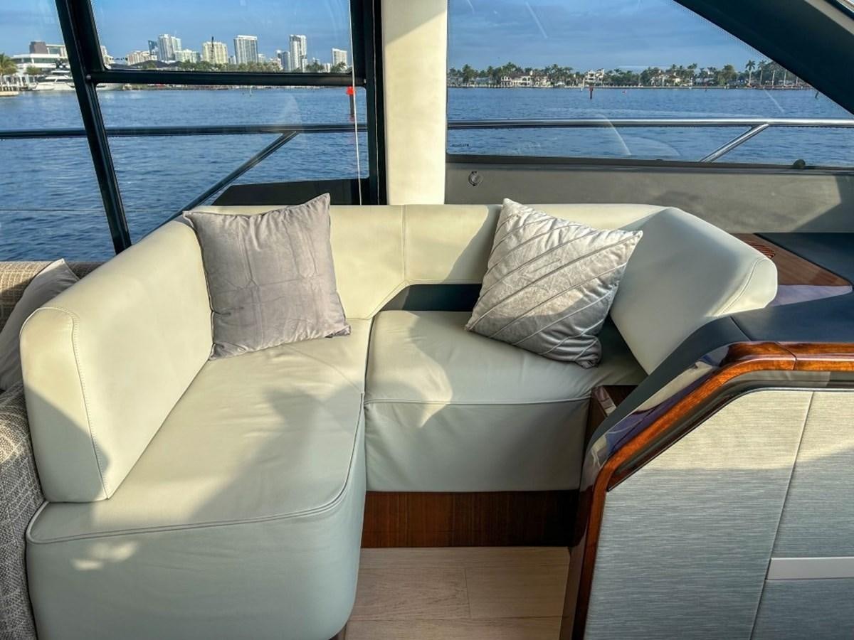 a couple of couches in a room with a window aboard 2024 NEW SQUADRON 68 FAIRLINE Yacht for Sale