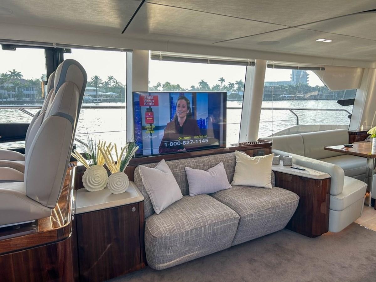 a living room with a large screen aboard 2024 NEW SQUADRON 68 FAIRLINE Yacht for Sale