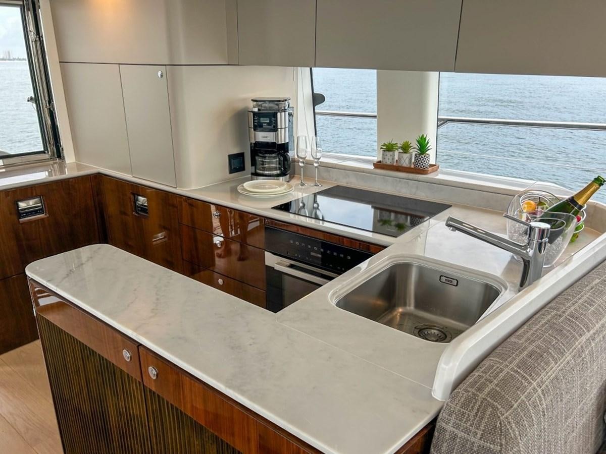 a kitchen with a sink and a window aboard 2024 NEW SQUADRON 68 FAIRLINE Yacht for Sale