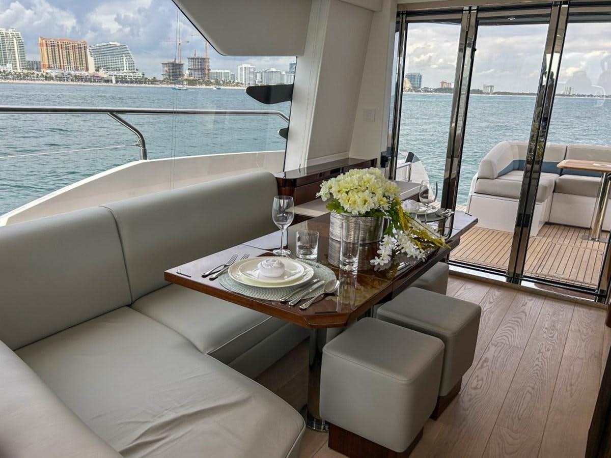 a room with a table and chairs aboard 2024 NEW SQUADRON 68 FAIRLINE Yacht for Sale