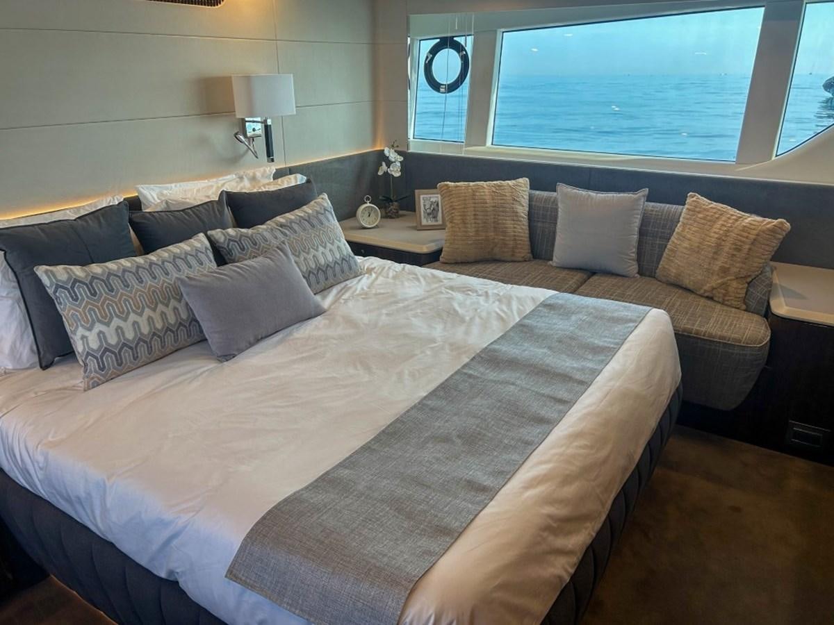 a bed with pillows and a couch aboard 2024 NEW SQUADRON 68 FAIRLINE Yacht for Sale