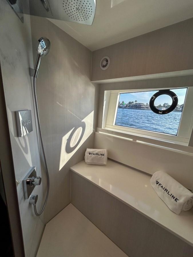 a bathroom with a sink and a telephone aboard 2024 NEW SQUADRON 68 FAIRLINE Yacht for Sale