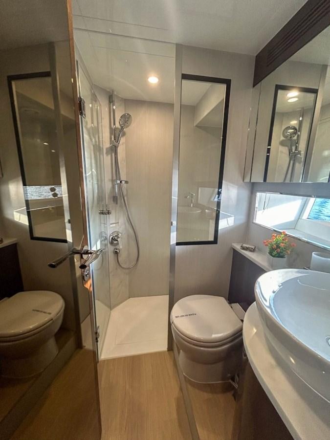 a bathroom with a glass shower aboard 2024 NEW SQUADRON 68 FAIRLINE Yacht for Sale