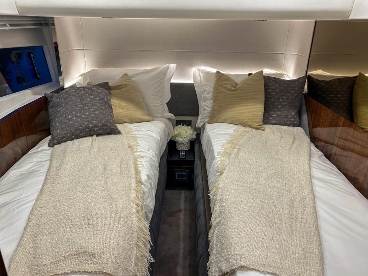 a bed with pillows aboard 2024 NEW SQUADRON 68 FAIRLINE Yacht for Sale