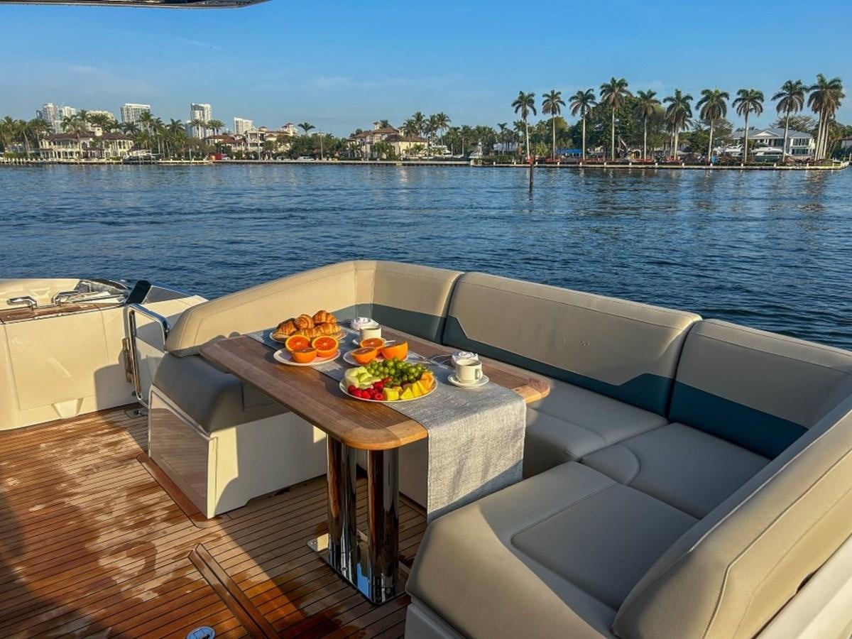 a table with fruit on it by the water aboard 2024 NEW SQUADRON 68 FAIRLINE Yacht for Sale