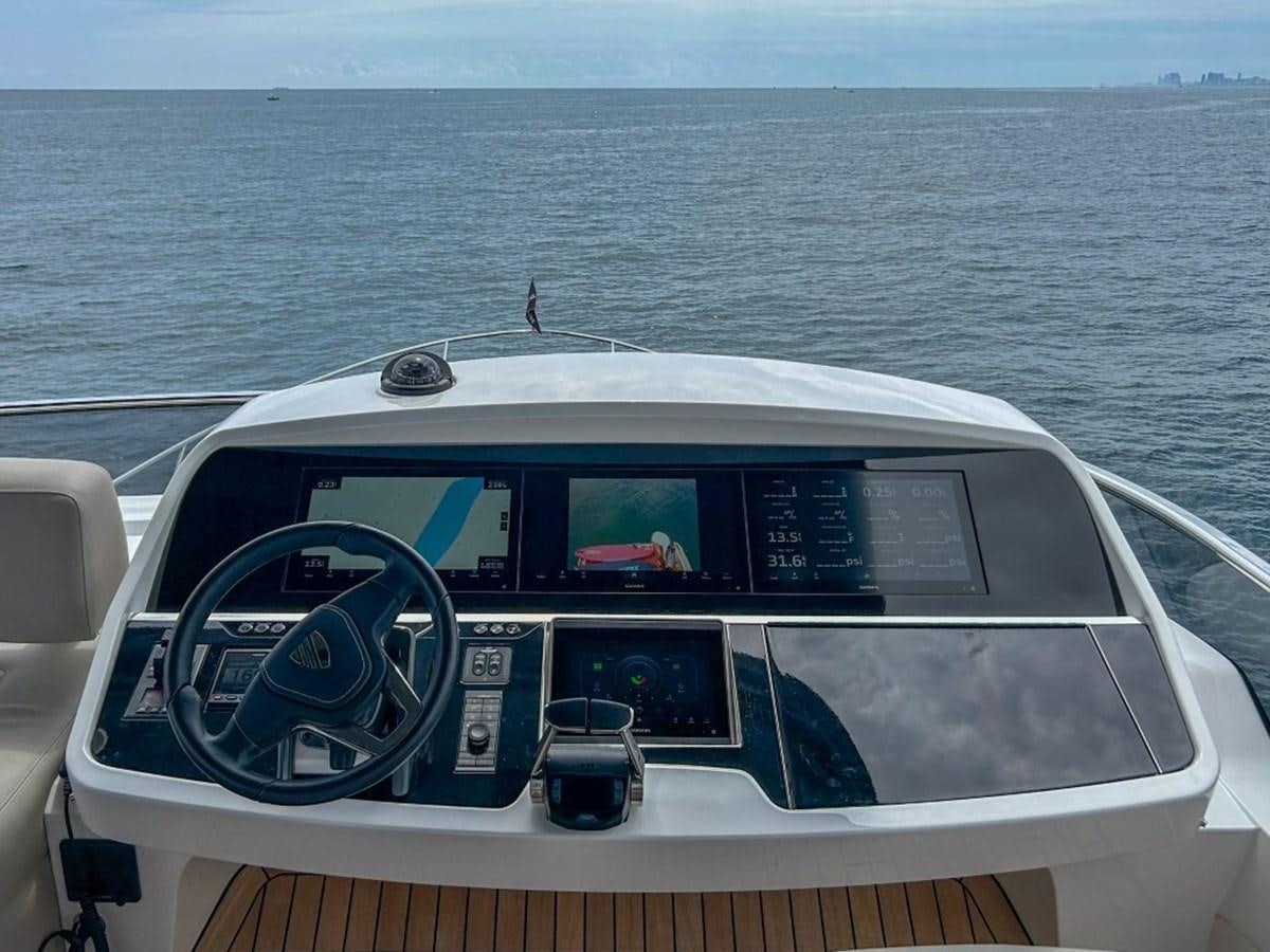 a boat with a steering wheel and steering wheel on the front aboard 2024 NEW SQUADRON 68 FAIRLINE Yacht for Sale