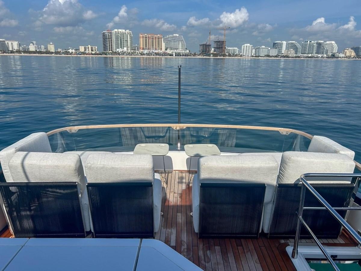 a deck with chairs and a body of water in the background aboard 2024 NEW SQUADRON 68 FAIRLINE Yacht for Sale
