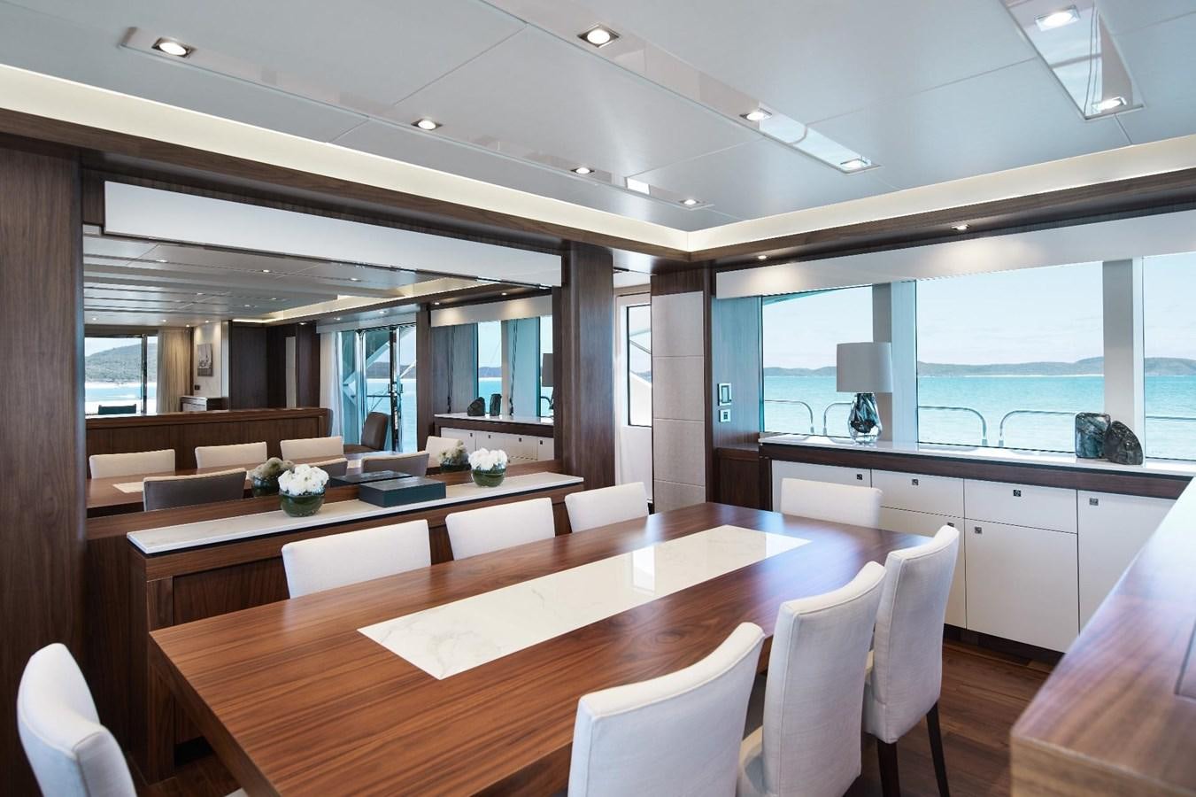 a room with a table chairs and a window aboard GEORGE P Yacht for Sale