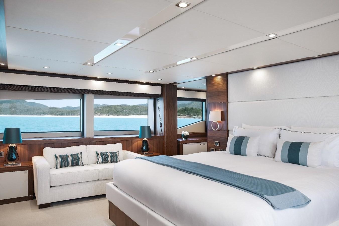 a room with a bed and a large window aboard GEORGE P Yacht for Sale