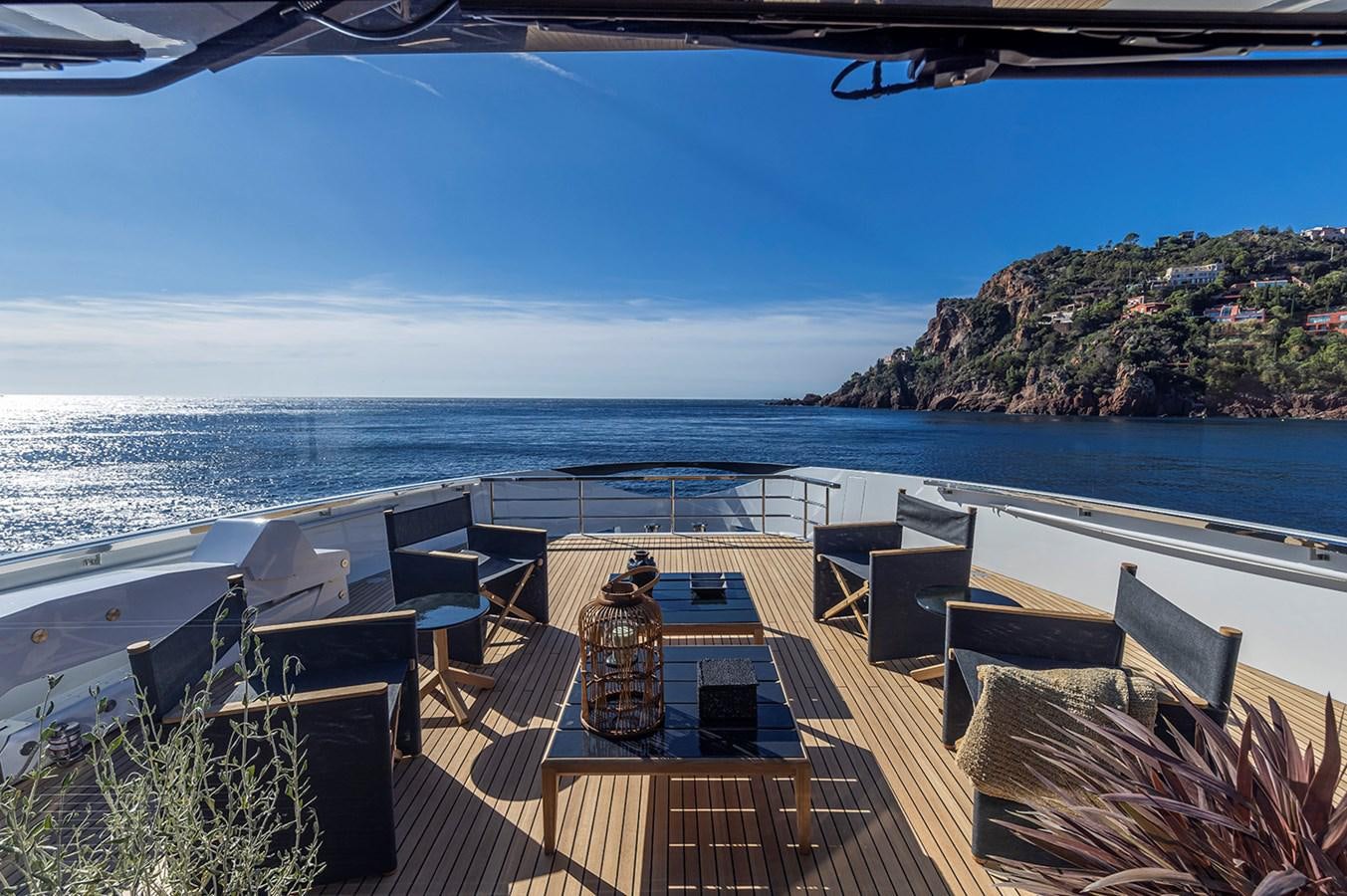a deck with chairs and a body of water in the background aboard ARCADIA 96 Yacht for Sale