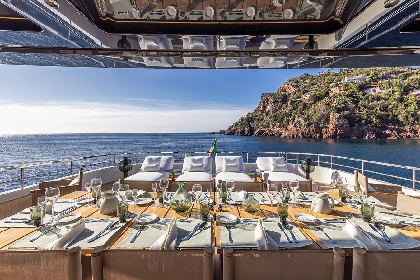 a pool with tables and chairs on it aboard ARCADIA 96 Yacht for Sale