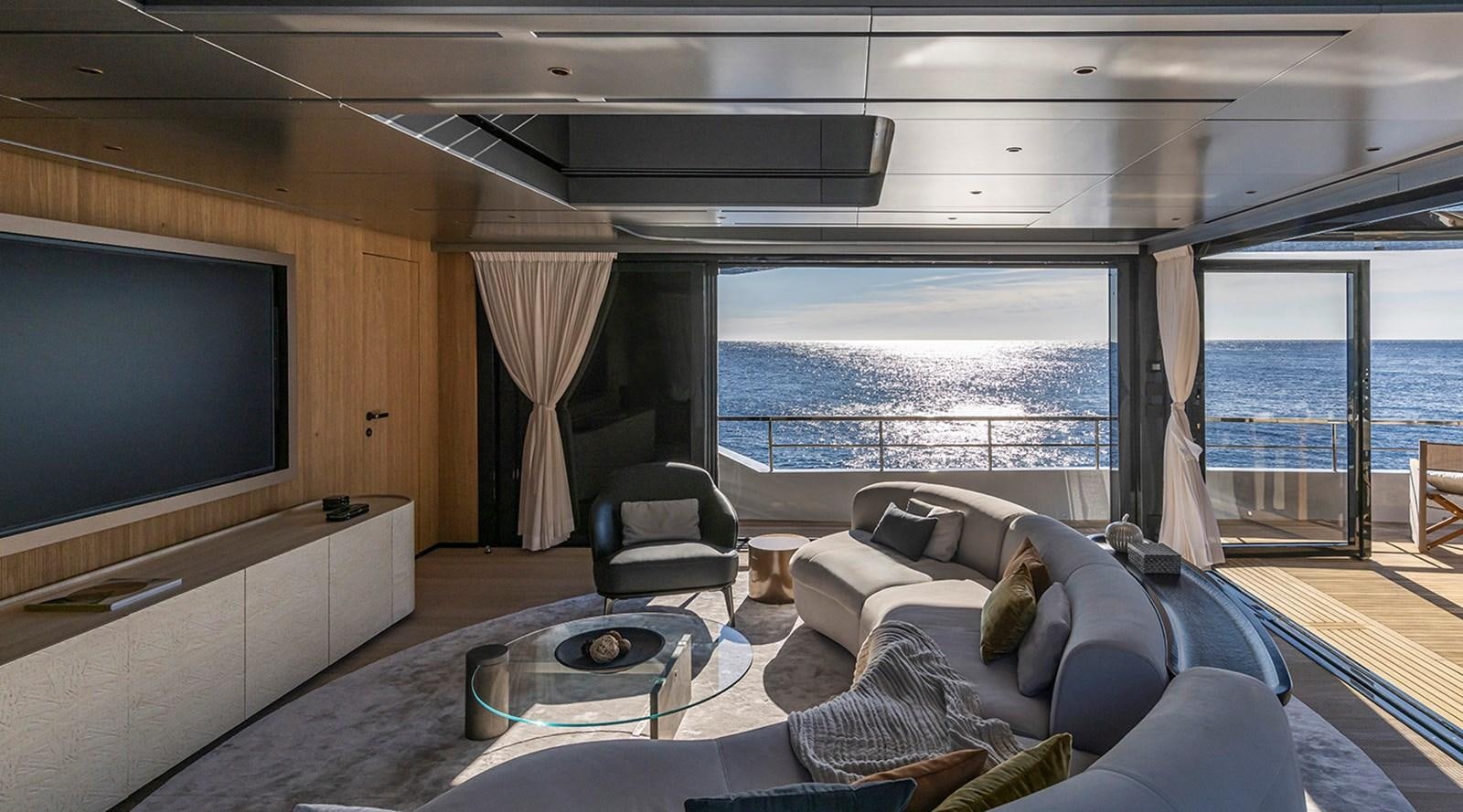 a living room with a large flat screen tv and a large window aboard ARCADIA 96 Yacht for Sale