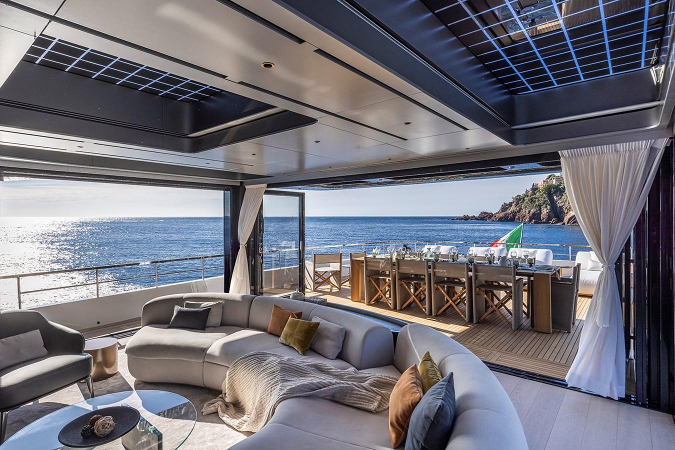 a living room with a large balcony overlooking the ocean aboard ARCADIA 96 Yacht for Sale
