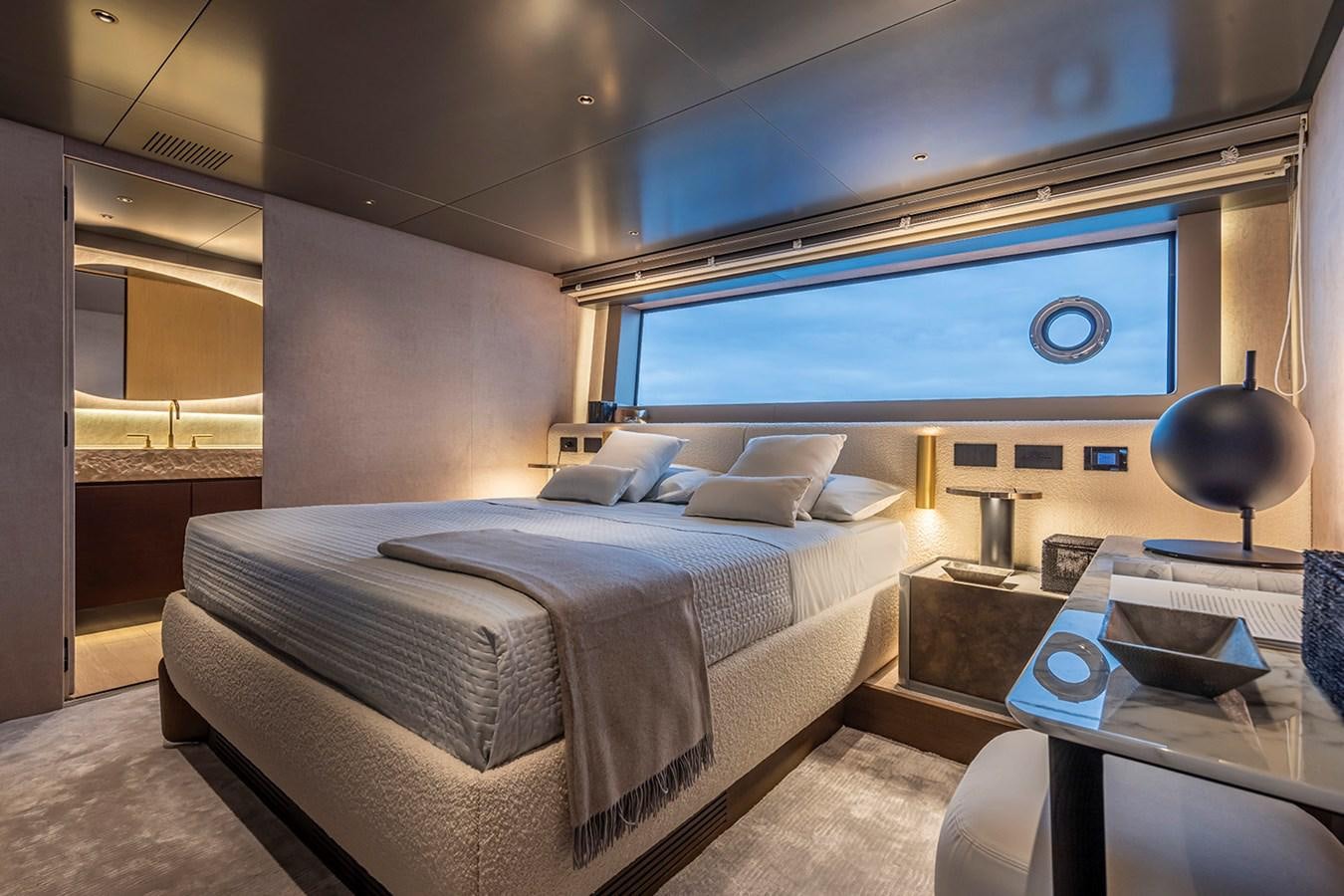 a room with a bed and a table aboard ARCADIA 96 Yacht for Sale