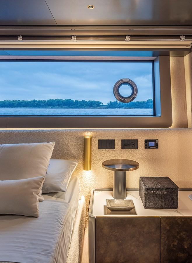 a room with a bed and a window aboard ARCADIA 96 Yacht for Sale