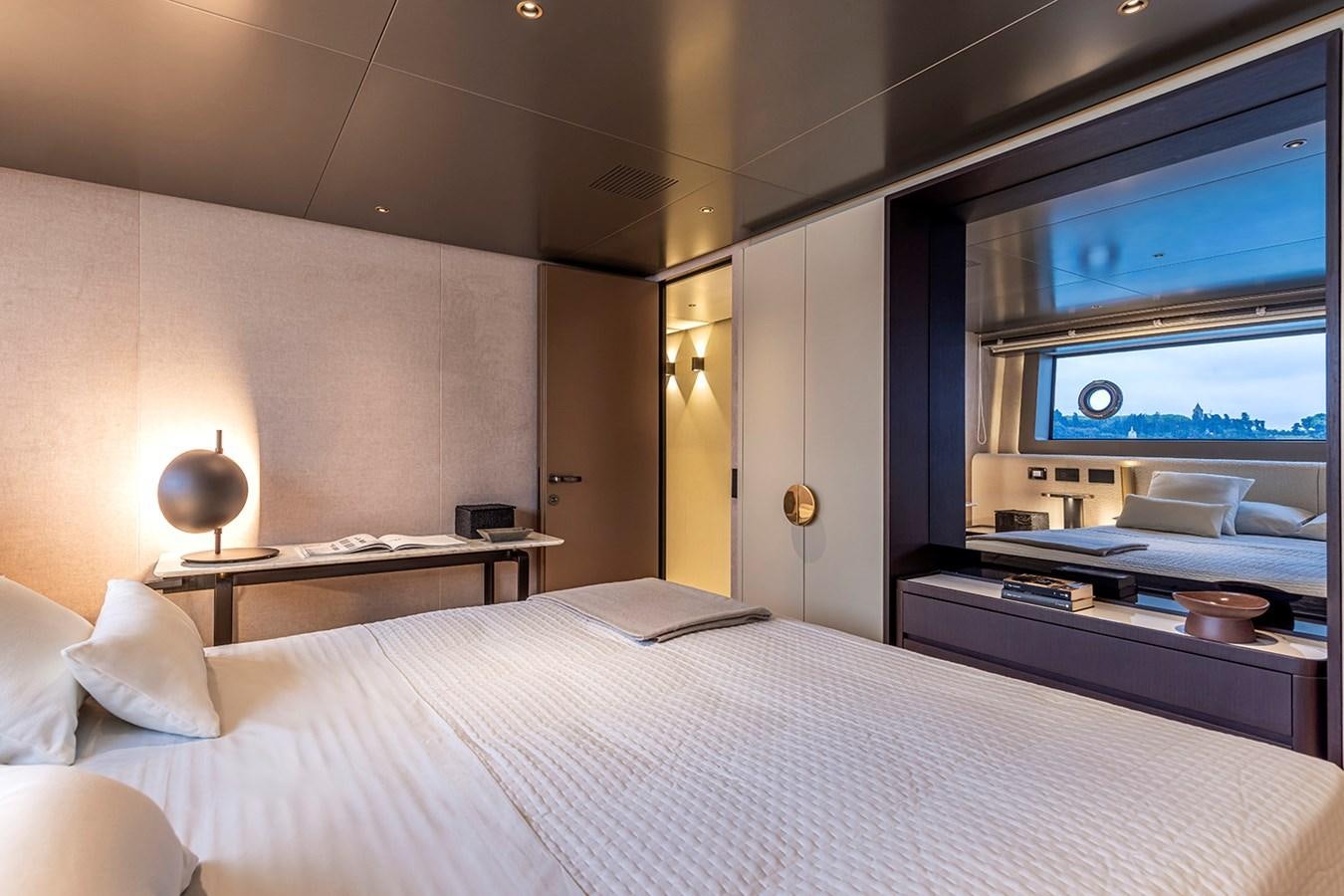 a bed with a white bed spread aboard ARCADIA 96 Yacht for Sale