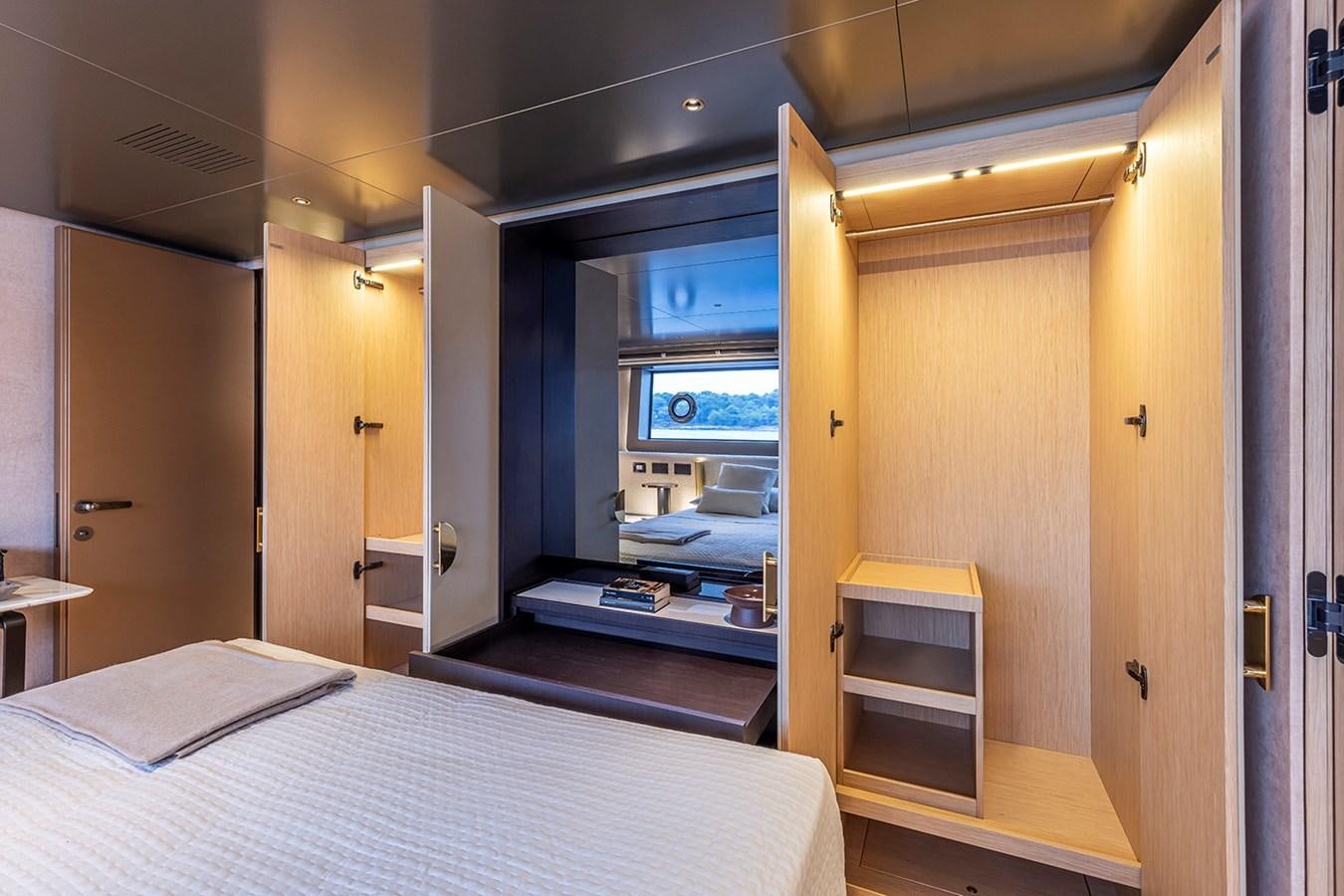 a room with a bed and a mirror aboard ARCADIA 96 Yacht for Sale