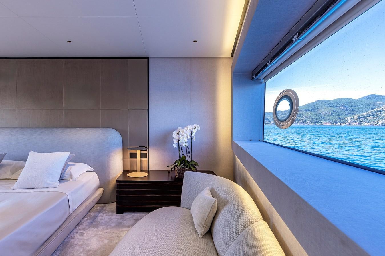 a room with a bed and a large window aboard ARCADIA 96 Yacht for Sale