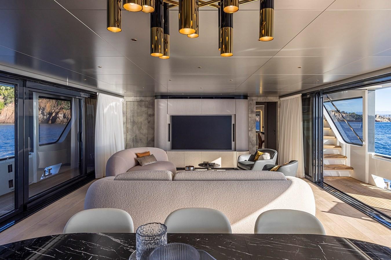 a living room with a large screen aboard ARCADIA 96 Yacht for Sale