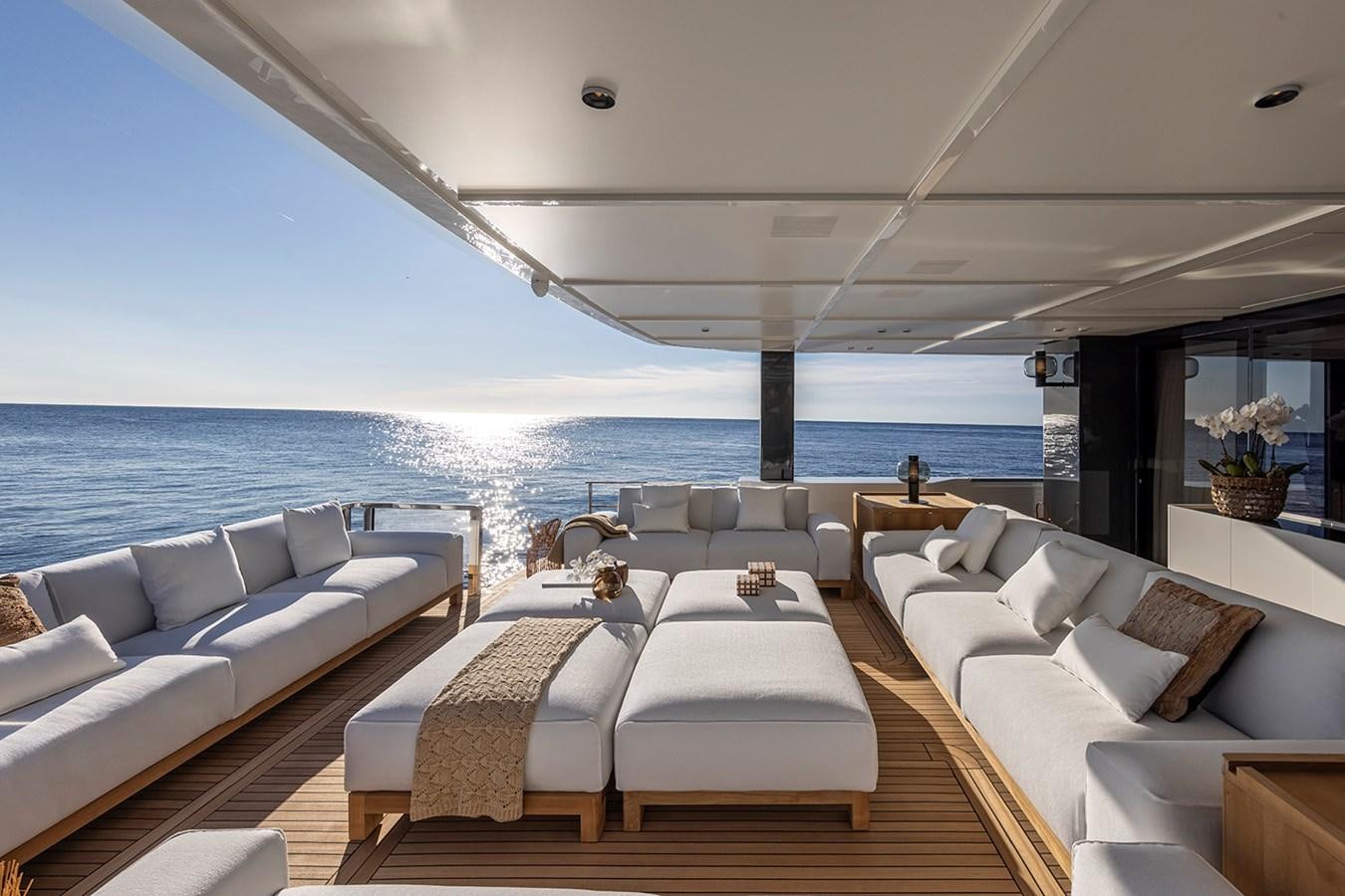 a room with a couch and a table and a large body of water aboard ARCADIA 96 Yacht for Sale
