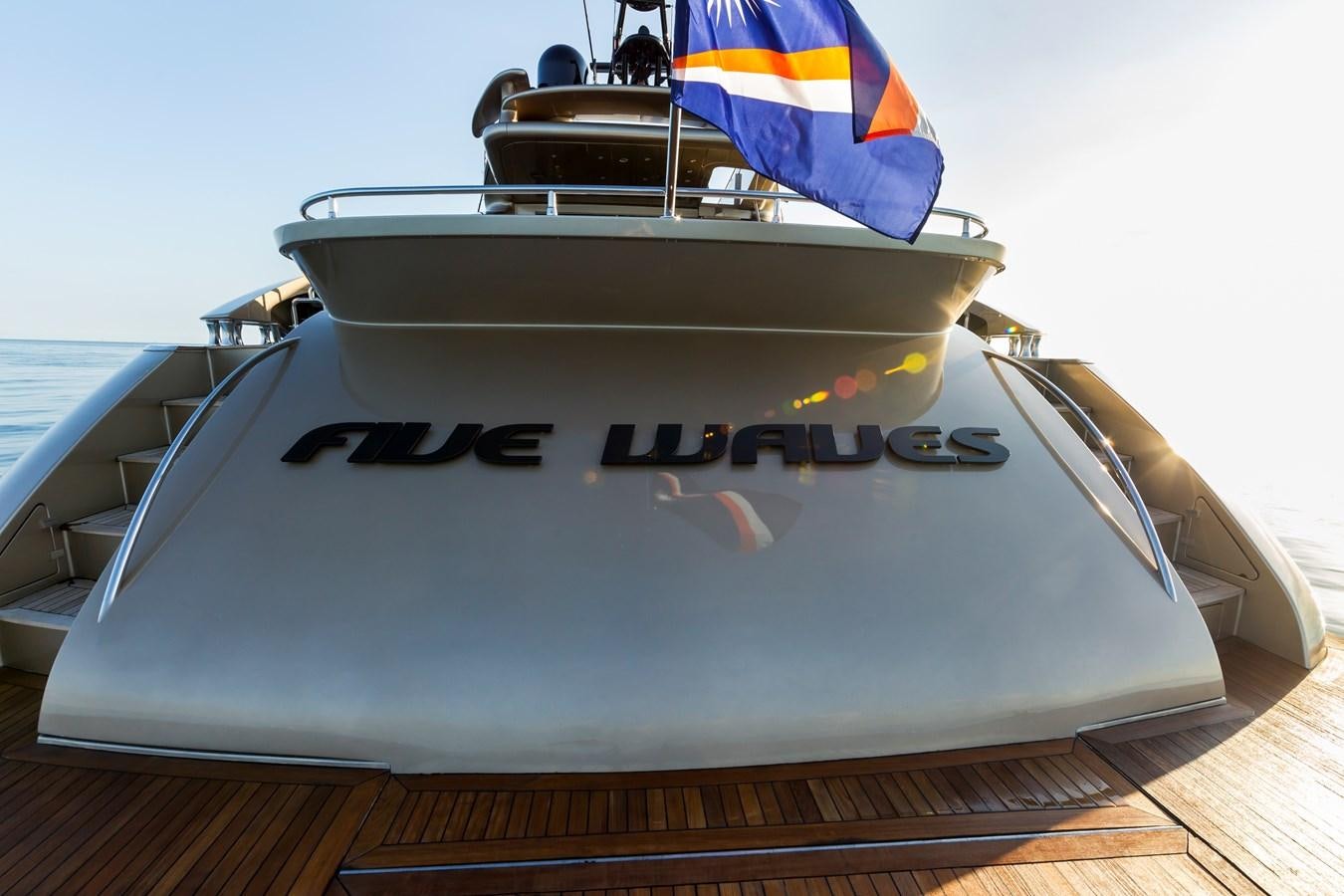 a white boat with black and white stripes on it aboard FIVE WAVES Yacht for Sale