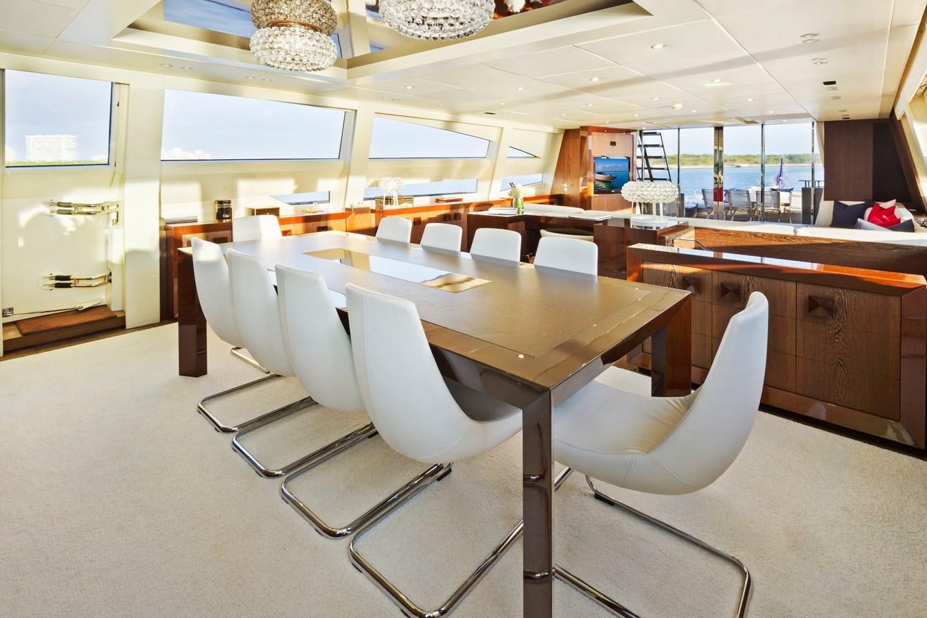 a room with a table and chairs aboard FIVE WAVES Yacht for Sale