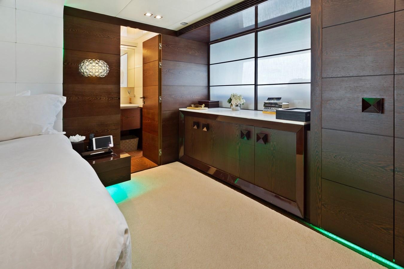 a bedroom with a bed and a desk aboard FIVE WAVES Yacht for Sale