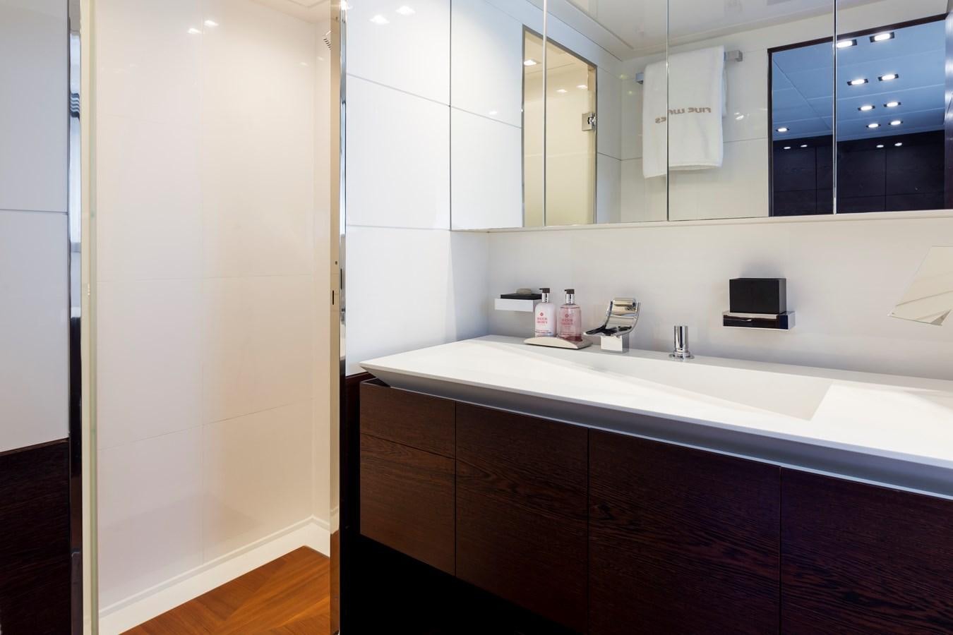 a bathroom with a sink and a mirror aboard FIVE WAVES Yacht for Sale