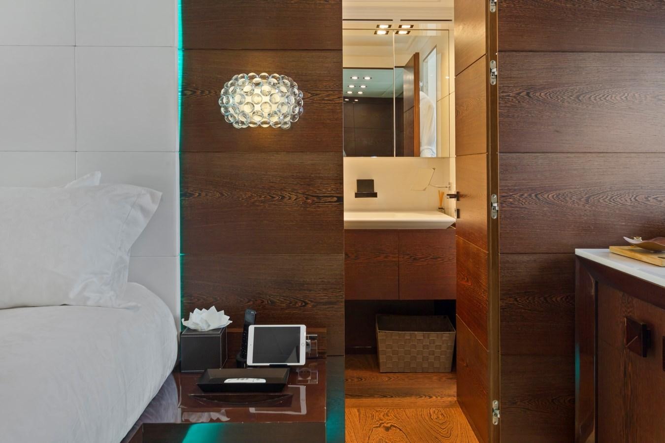 a room with a bed and a desk aboard FIVE WAVES Yacht for Sale